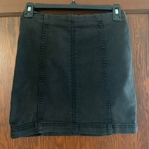 Free People black denim mini skirt w/ back zipper. Size 2. Denim stretch.